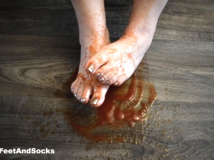 Feet Are Splashed With Tomato Sauce. Crush Food Crushing