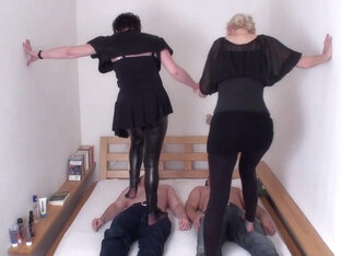 Brunette and blonde are trampling on their slaves by Femdom Austria
